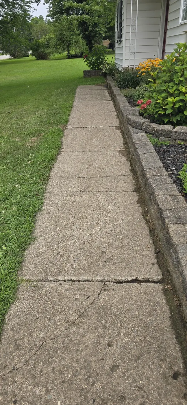 Clean residential walkway after controlled surface cleaning