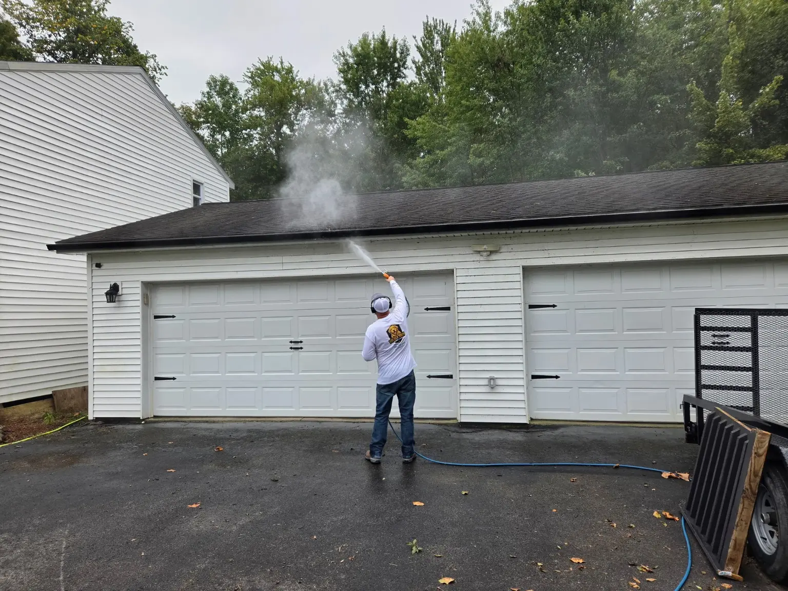 Nick applying a controlled exterior wash to the garage